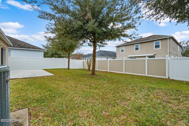 view of yard with a patio and central AC unit