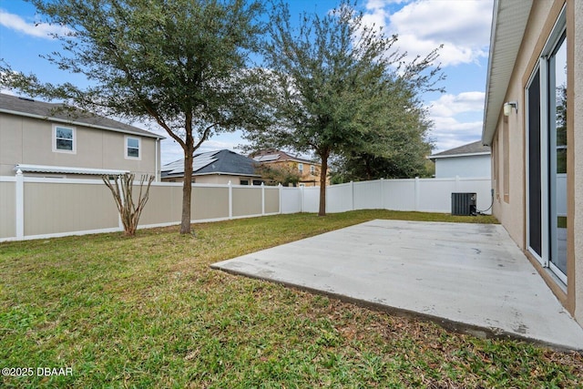 view of yard with central AC unit and a patio