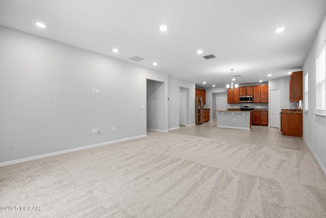 unfurnished living room featuring sink and light colored carpet