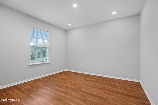 unfurnished room featuring hardwood / wood-style flooring