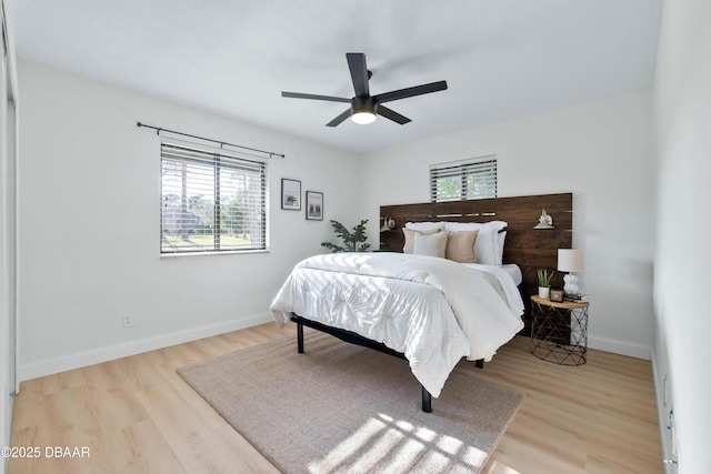 bedroom with ceiling fan and light hardwood / wood-style floors