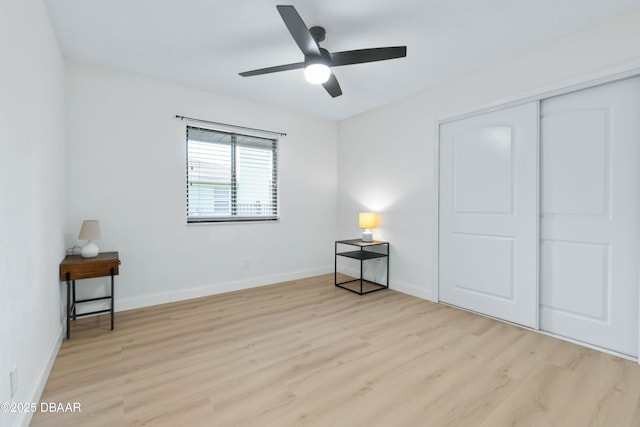 bedroom featuring light hardwood / wood-style flooring, a closet, and ceiling fan