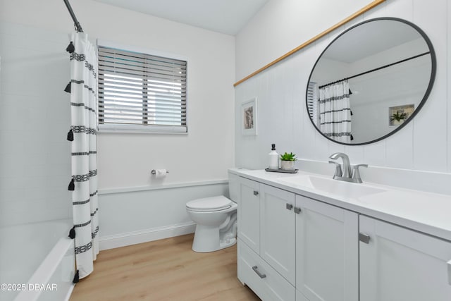 full bathroom featuring hardwood / wood-style flooring, vanity, shower / tub combo with curtain, and toilet