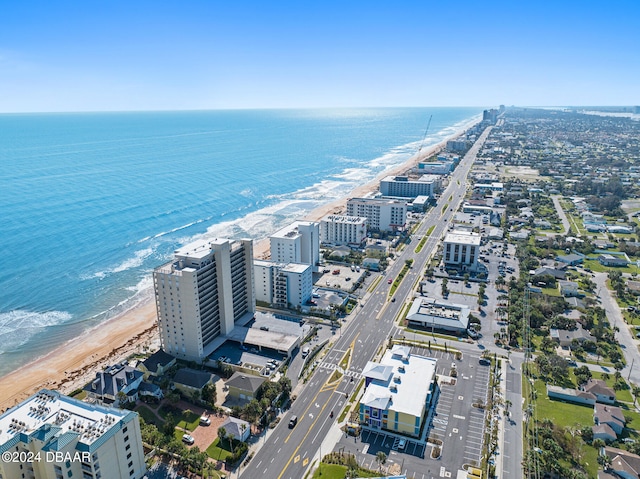 birds eye view of property featuring a water view and a beach view