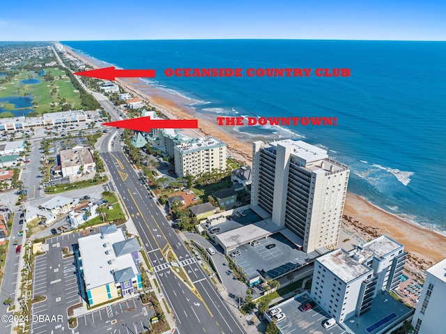 birds eye view of property with a beach view and a water view