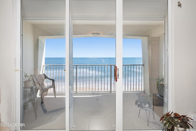 balcony featuring a view of the beach and a water view