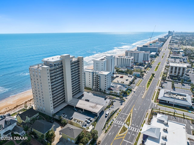 drone / aerial view featuring a beach view and a water view