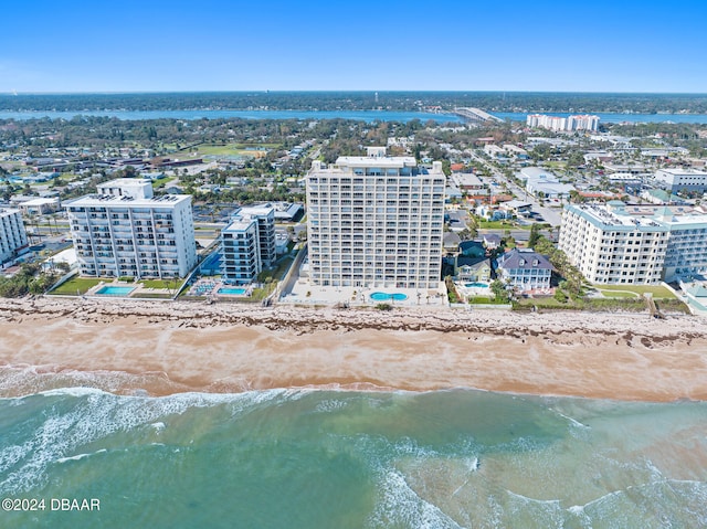 drone / aerial view with a beach view and a water view