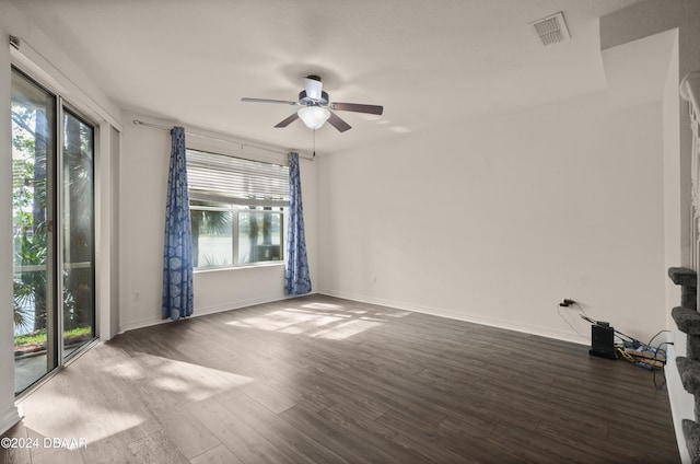 spare room with dark hardwood / wood-style floors and ceiling fan