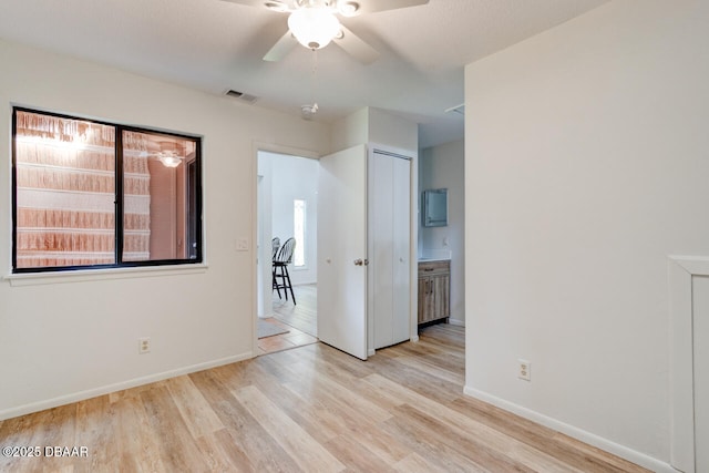 5 Park Pl, Ormond Beach, FL 32174 - unfurnished bedroom with light wood-style floors, multiple windows, and a closet