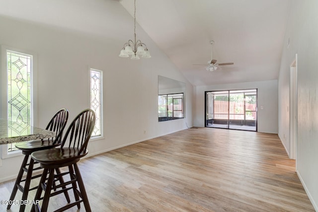 5 Park Pl, Ormond Beach, FL 32174 - dining area featuring high vaulted ceiling, a ceiling fan, light wood-style flooring, and a chandelier