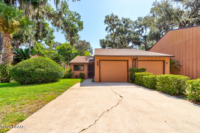 5 Park Pl, Ormond Beach, FL 32174 - view of front of home with a front lawn, concrete driveway, and an attached garage