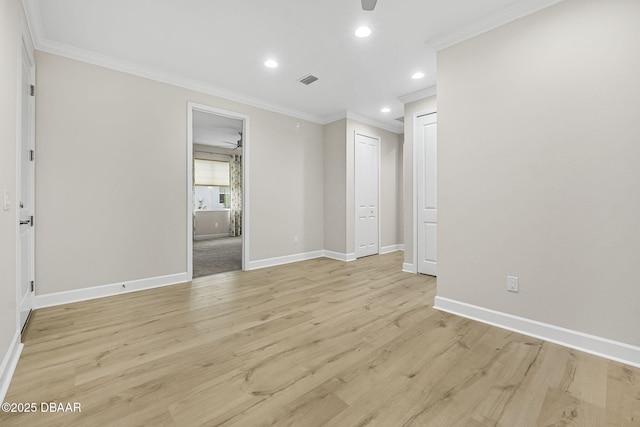 spare room featuring crown molding, ceiling fan, and light hardwood / wood-style flooring