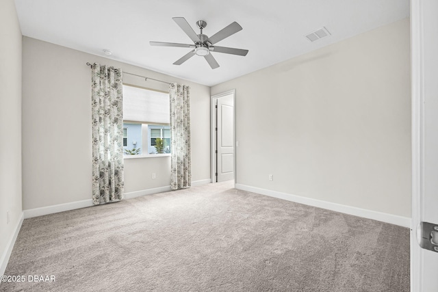 unfurnished room with ceiling fan and carpet floors