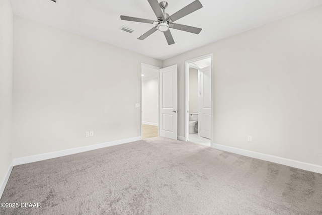 unfurnished bedroom with ensuite bathroom, ceiling fan, and carpet