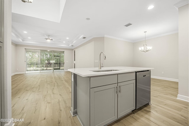 kitchen featuring gray cabinets, light hardwood / wood-style floors, an island with sink, sink, and stainless steel dishwasher