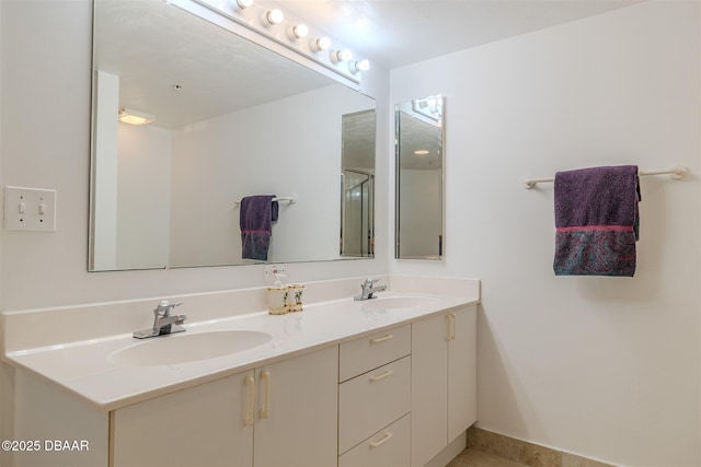 bathroom featuring a sink and double vanity