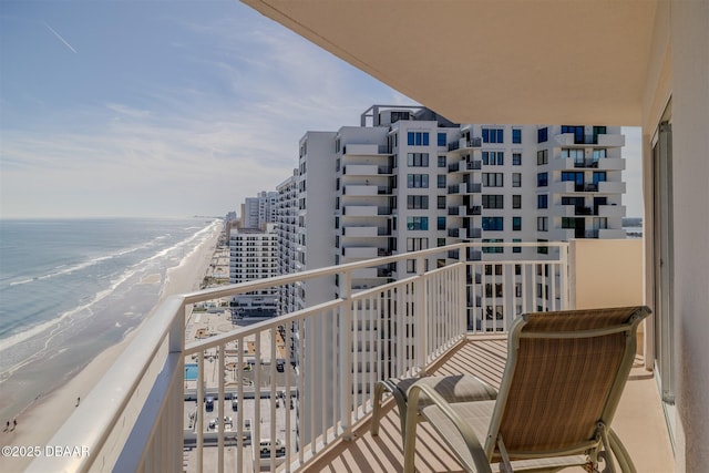 balcony featuring a water view and a view of the beach