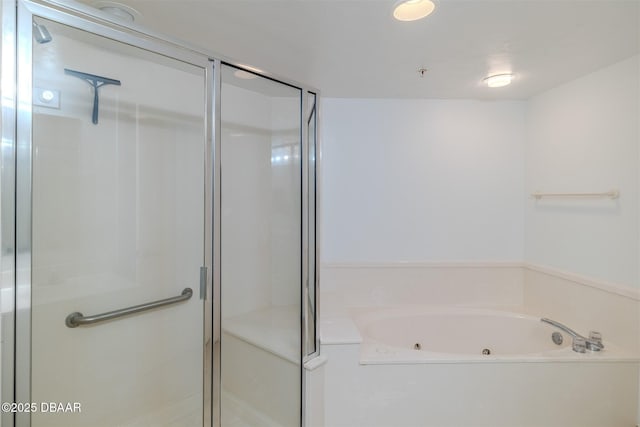 full bathroom featuring a tub with jets and a stall shower