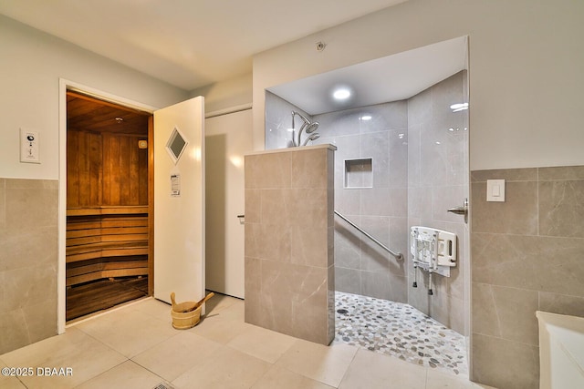 full bath featuring tile patterned flooring, visible vents, tile walls, and walk in shower