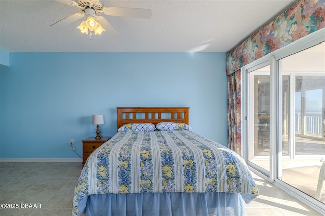 unfurnished bedroom with a ceiling fan, access to outside, a textured ceiling, and tile patterned floors