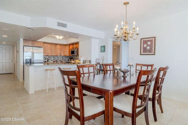 dining area featuring light tile patterned floors, visible vents, and baseboards