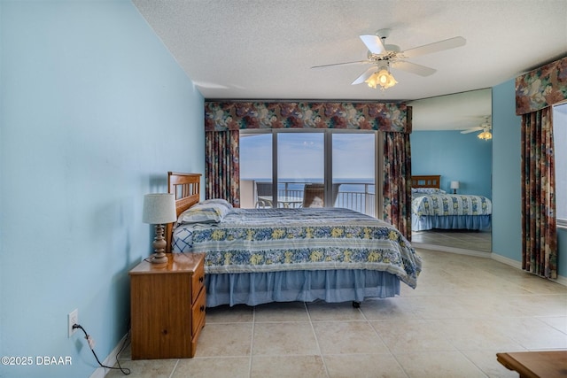 bedroom with light tile patterned floors, ceiling fan, baseboards, and a textured ceiling