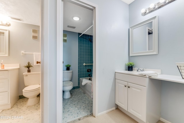 full bathroom featuring tile patterned floors, vanity, toilet, and tiled shower / bath combo