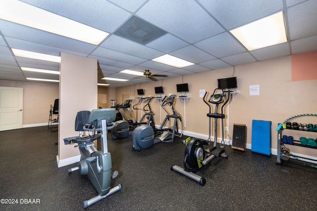 exercise room featuring ceiling fan and a drop ceiling