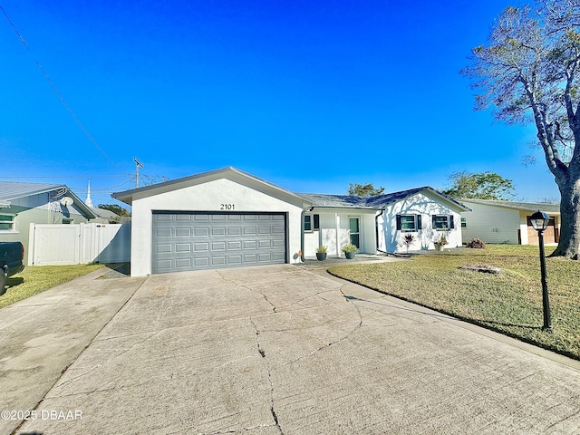 ranch-style home featuring a front lawn and a garage