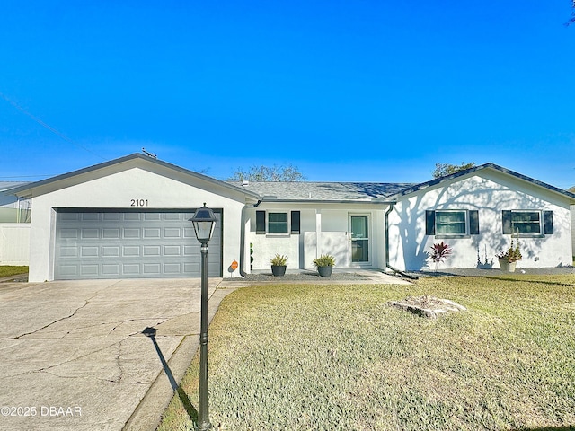 ranch-style home featuring a garage and a front lawn