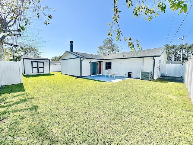 back of house featuring a shed, central AC, a patio, and a yard