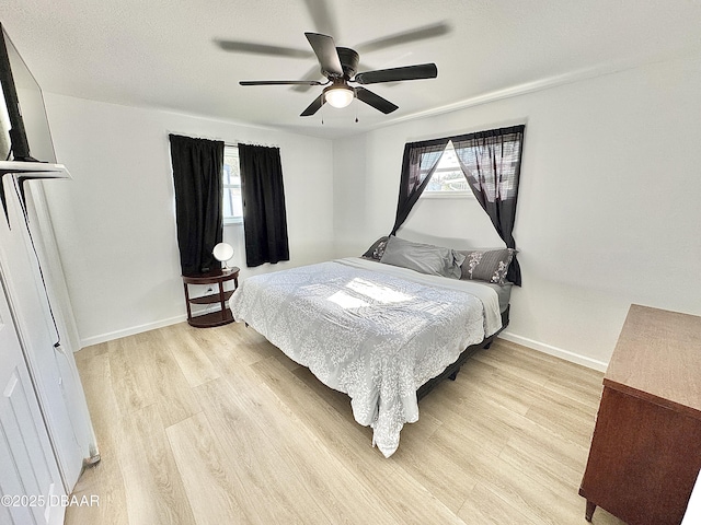 bedroom with ceiling fan and light hardwood / wood-style floors