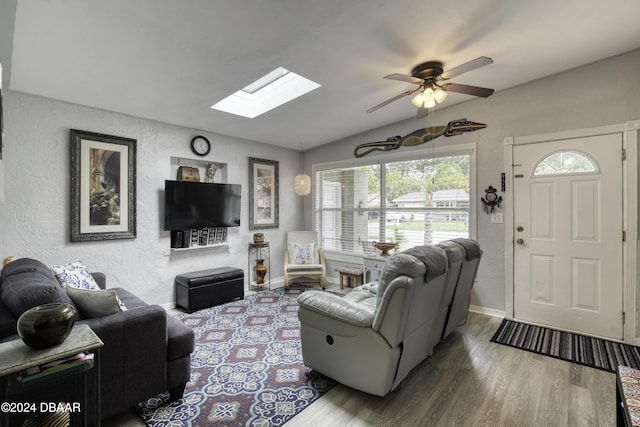 living room featuring ceiling fan, hardwood / wood-style floors, and lofted ceiling