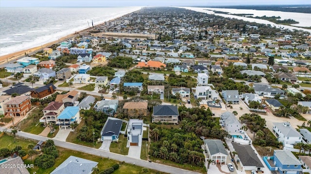 bird's eye view with a water view and a beach view