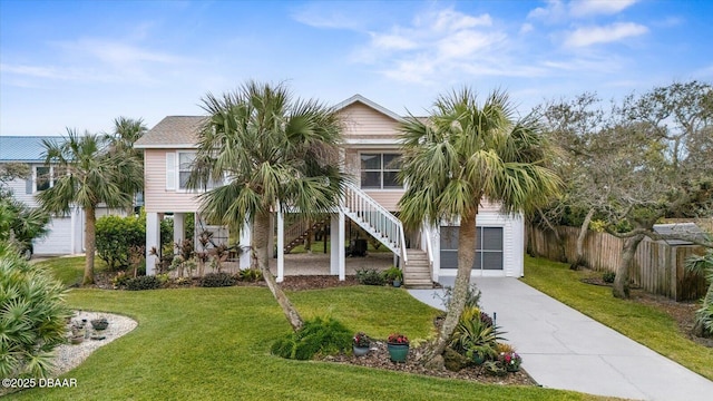 beach home with a front yard and a porch