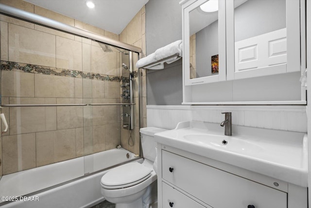 full bathroom with toilet, bath / shower combo with glass door, and vanity