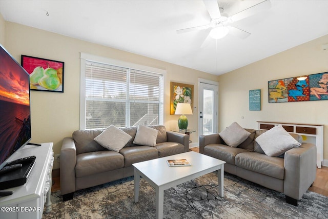 living room featuring ceiling fan, vaulted ceiling, and dark hardwood / wood-style floors