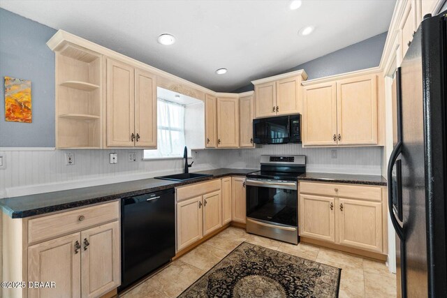 kitchen with sink, light brown cabinets, light tile patterned floors, and black appliances