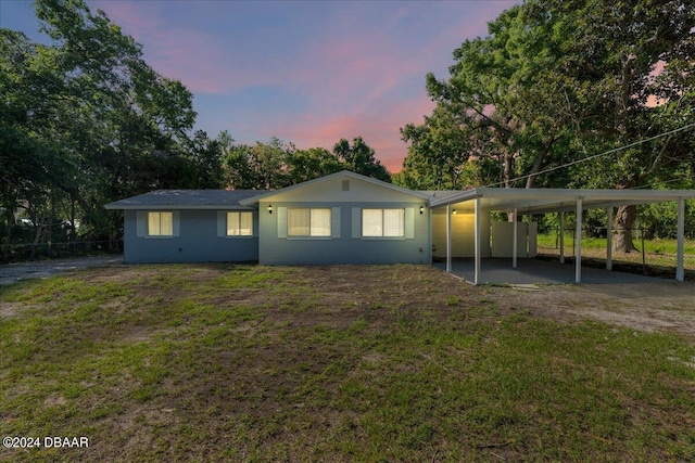 view of front of house with a lawn and a carport