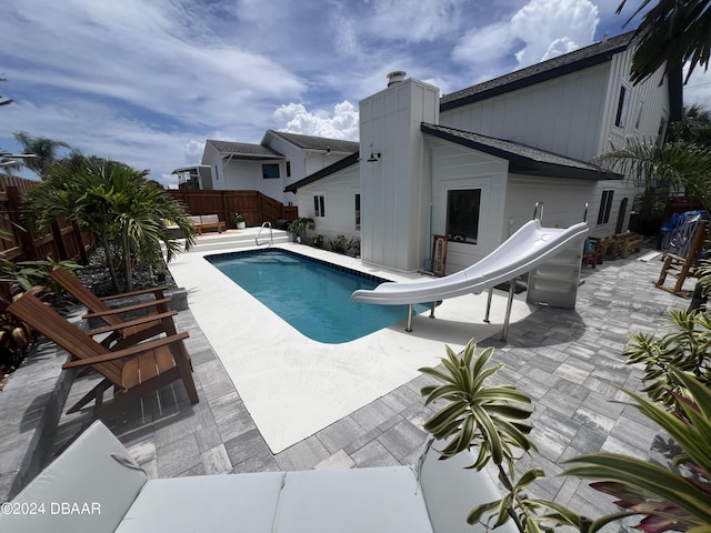 view of swimming pool featuring a patio area and a water slide