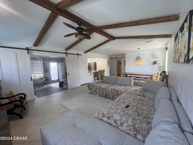 living room with lofted ceiling with beams, a barn door, light tile patterned flooring, and ceiling fan with notable chandelier