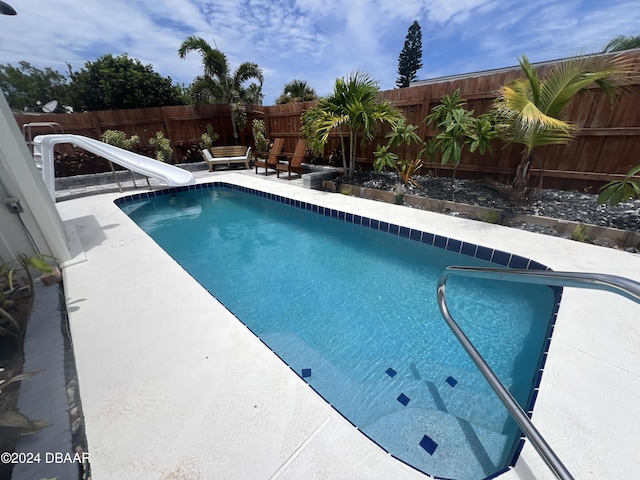 view of swimming pool featuring a water slide