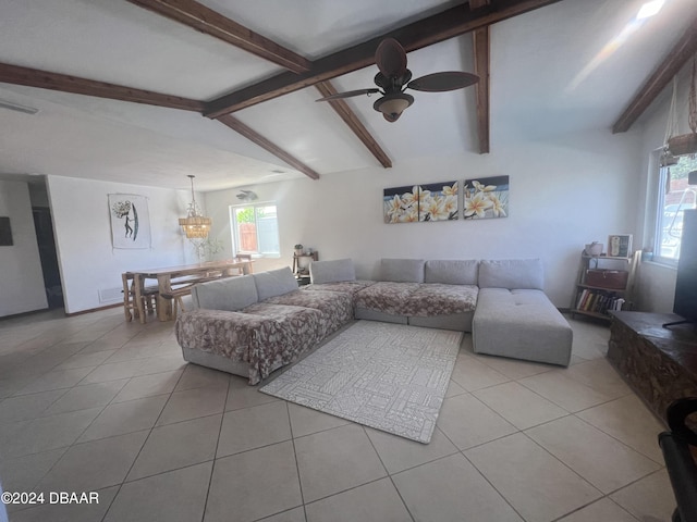 tiled living room with lofted ceiling with beams and ceiling fan with notable chandelier