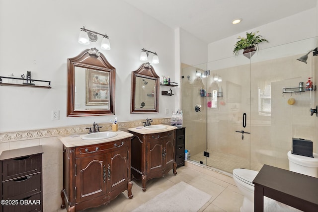 bathroom featuring tile walls, tile patterned flooring, vanity, toilet, and walk in shower