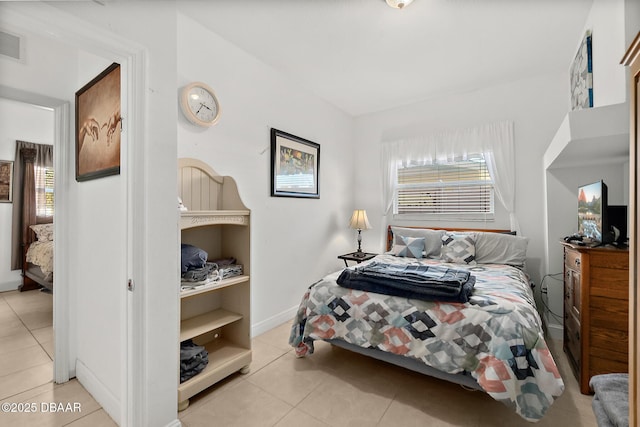 bedroom with light tile patterned flooring