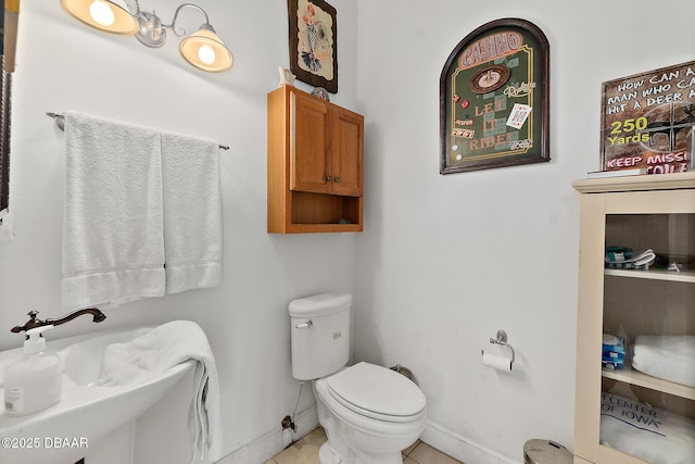 bathroom with tile patterned flooring and toilet