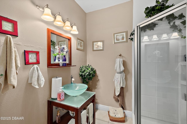 bathroom with tile patterned floors, a shower with shower door, and vanity