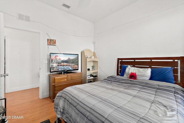 bedroom with hardwood / wood-style floors