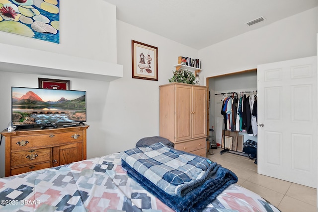 bedroom with light tile patterned flooring and a closet